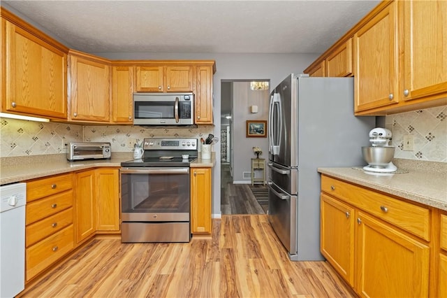 65 Sotheby Dr, Greece, NY 14626 - kitchen with appliances with stainless steel finishes, light wood-style flooring, light countertops, and tasteful backsplash