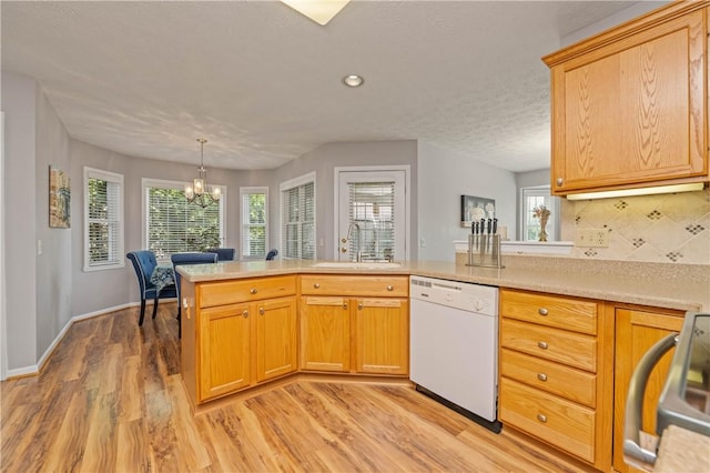 65 Sotheby Dr, Greece, NY 14626 - kitchen with white dishwasher, light countertops, light wood finished floors, a chandelier, and recessed lighting