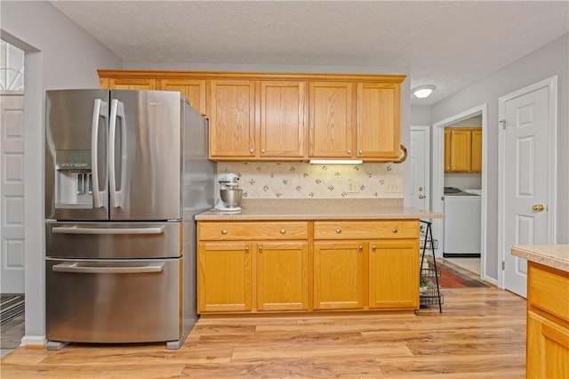 65 Sotheby Dr, Greece, NY 14626 - kitchen with stainless steel fridge, light countertops, light wood finished floors, and separate washer and dryer