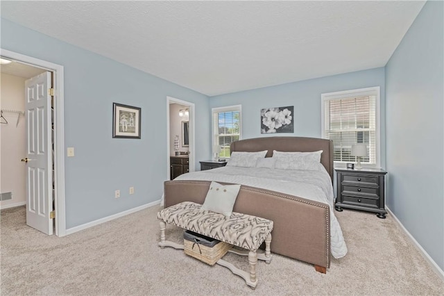 65 Sotheby Dr, Greece, NY 14626 - carpeted bedroom featuring a spacious closet and connected bathroom