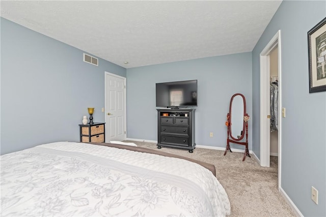65 Sotheby Dr, Greece, NY 14626 - carpeted bedroom featuring a spacious closet and a textured ceiling