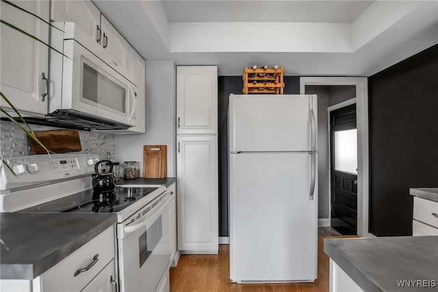 1871 Eggert Rd, Amherst, NY 14226 - kitchen with white appliances, dark countertops, white cabinetry, light wood-style flooring, and backsplash
