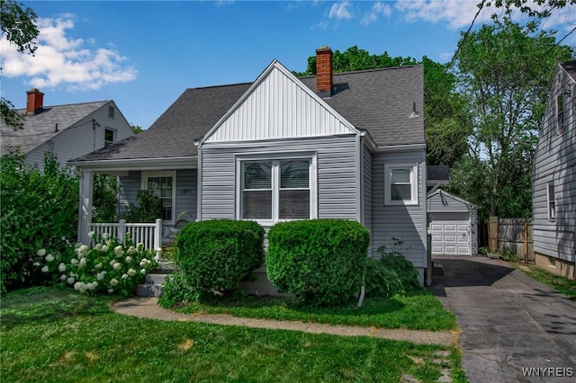 1871 Eggert Rd, Amherst, NY 14226 - bungalow-style home with a chimney, an outdoor structure, roof with shingles, a front yard, and board and batten siding