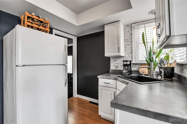 1871 Eggert Rd, Amherst, NY 14226 - kitchen featuring freestanding refrigerator, white cabinetry, dark countertops, and wood finished floors
