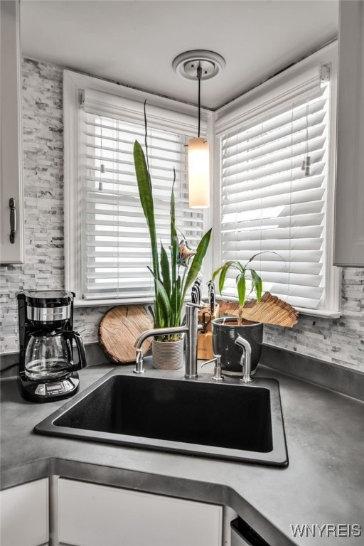 1871 Eggert Rd, Amherst, NY 14226 - kitchen view of white cabinets, decorative backsplash, and dark countertops