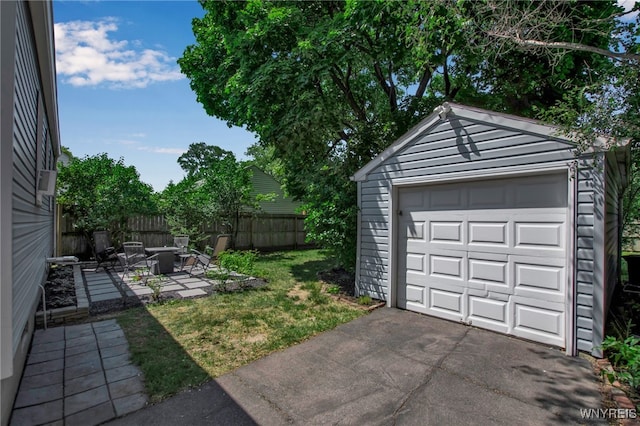 1871 Eggert Rd, Amherst, NY 14226 - view of yard featuring an outdoor fire pit, a garage, an outdoor structure, driveway, and a patio area
