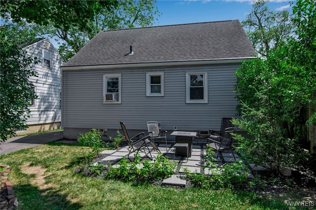 1871 Eggert Rd, Amherst, NY 14226 - back of property with a shingled roof, a patio, and a yard