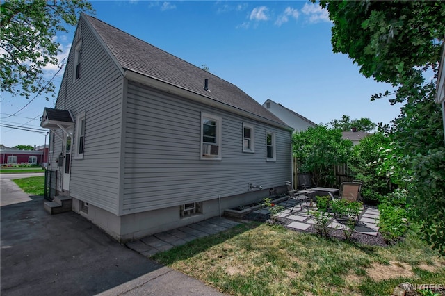 1871 Eggert Rd, Amherst, NY 14226 - view of property exterior featuring entry steps, a patio, and roof with shingles