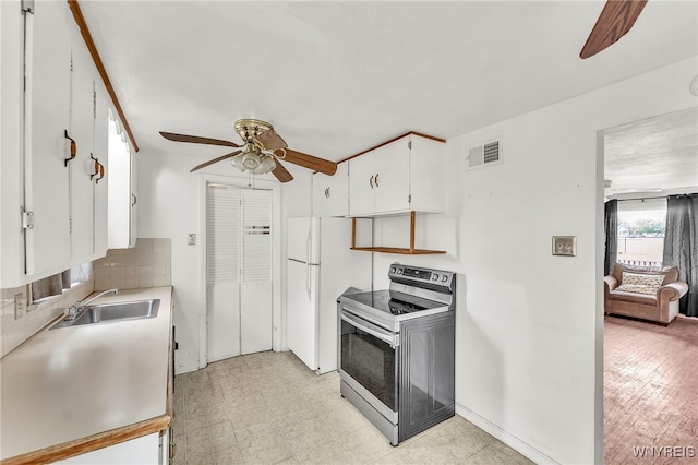 302 Midland Ave, Tonawanda, NY 14223 - kitchen with stainless steel range with electric cooktop, a ceiling fan, white cabinets, light countertops, and tasteful backsplash