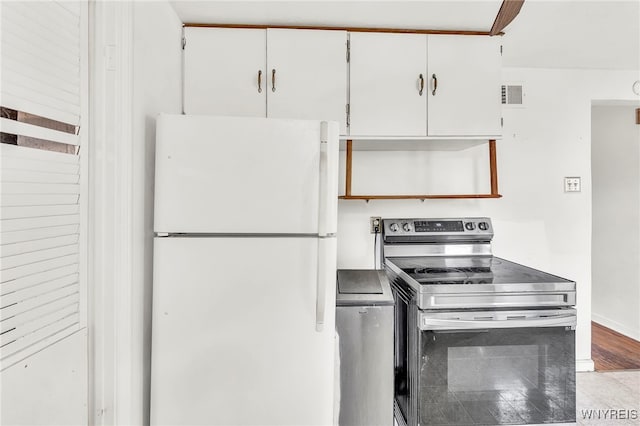 302 Midland Ave, Tonawanda, NY 14223 - kitchen with freestanding refrigerator, stainless steel range with electric stovetop, and white cabinets