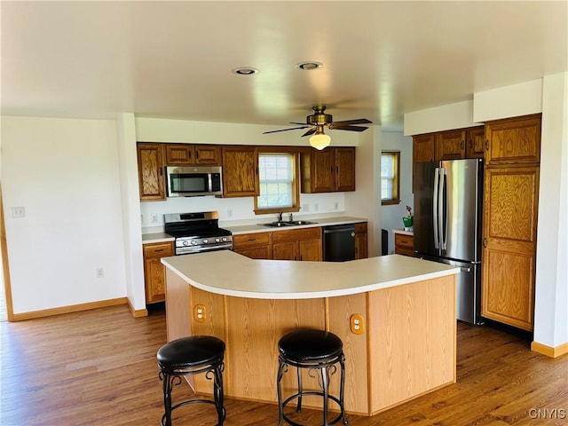 3370 Hicks Rd, Scipio, NY 13118 - kitchen with appliances with stainless steel finishes, a ceiling fan, light countertops, and dark wood finished floors