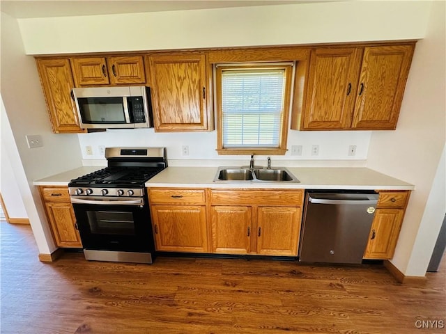 3370 Hicks Rd, Scipio, NY 13118 - kitchen with appliances with stainless steel finishes, brown cabinets, dark wood-style flooring, and light countertops