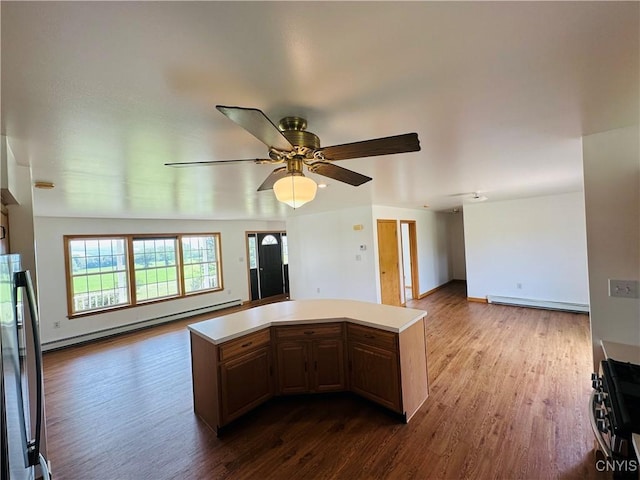 3370 Hicks Rd, Scipio, NY 13118 - kitchen with open floor plan, range with gas stovetop, freestanding refrigerator, dark wood-style flooring, and light countertops