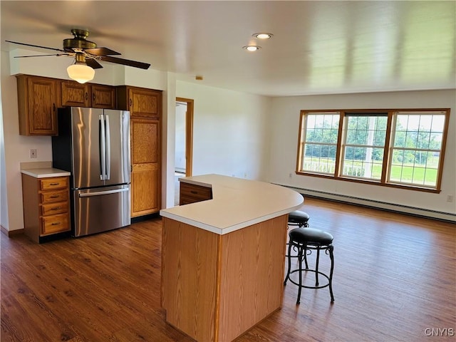 3370 Hicks Rd, Scipio, NY 13118 - kitchen with freestanding refrigerator, a baseboard radiator, dark wood finished floors, light countertops, and recessed lighting