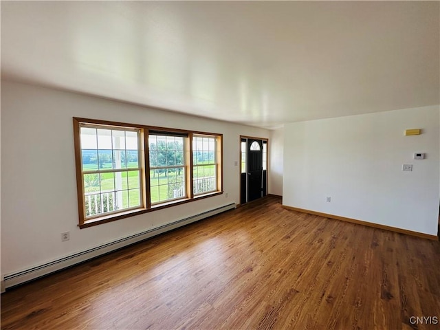 3370 Hicks Rd, Scipio, NY 13118 - spare room featuring a baseboard radiator and wood finished floors