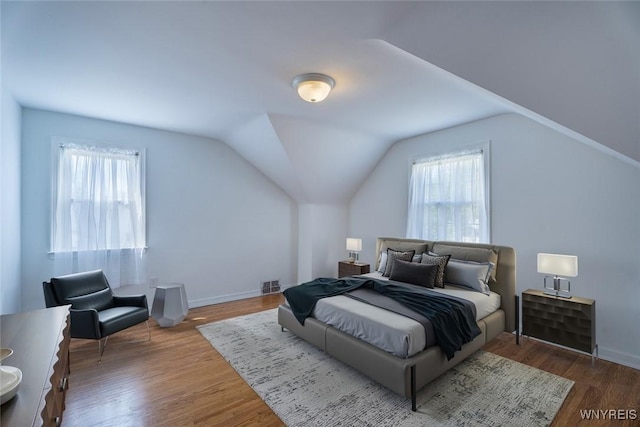 165 Kelvin Dr, Tonawanda, NY 14223 - bedroom with multiple windows, wood finished floors, and lofted ceiling