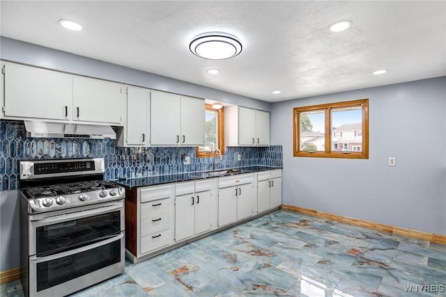 41 Dennis Ln, Cheektowaga, NY 14227 - kitchen with range with two ovens, under cabinet range hood, dark countertops, white cabinetry, and recessed lighting