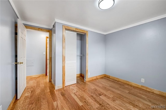 41 Dennis Ln, Cheektowaga, NY 14227 - unfurnished bedroom with light wood-style flooring, a closet, and ornamental molding