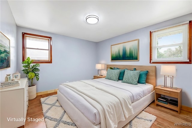 41 Dennis Ln, Cheektowaga, NY 14227 - bedroom with multiple windows and light wood finished floors