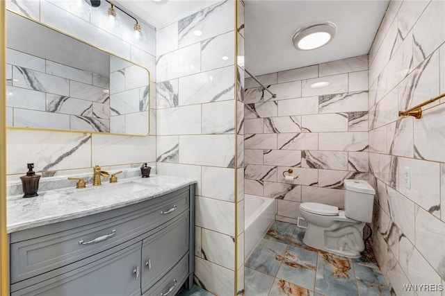 41 Dennis Ln, Cheektowaga, NY 14227 - bathroom featuring tile walls, vanity, marble look tile flooring, and washtub / shower combination