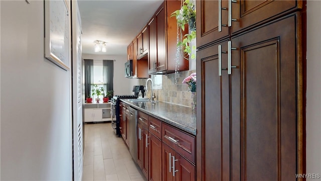 78 Heather Rd, Cheektowaga, NY 14225 - kitchen with stainless steel appliances, decorative backsplash, dark countertops, and light tile patterned floors