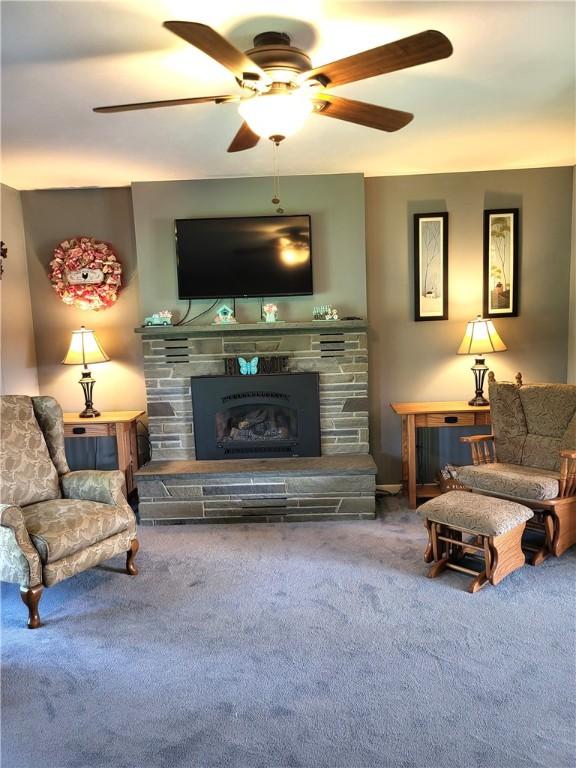 138 Dingman Hill Rd, Bainbridge, NY 13733 - living room with carpet, a fireplace, and ceiling fan
