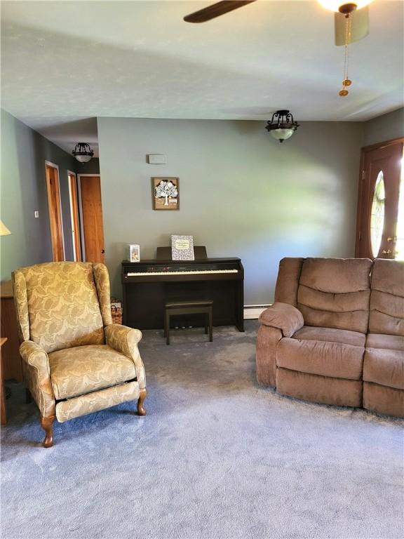 138 Dingman Hill Rd, Bainbridge, NY 13733 - carpeted living room with ceiling fan and baseboard heating