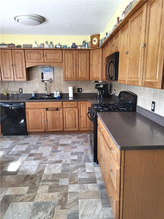 138 Dingman Hill Rd, Bainbridge, NY 13733 - kitchen featuring black appliances, dark countertops, brown cabinetry, backsplash, and light stone finish flooring