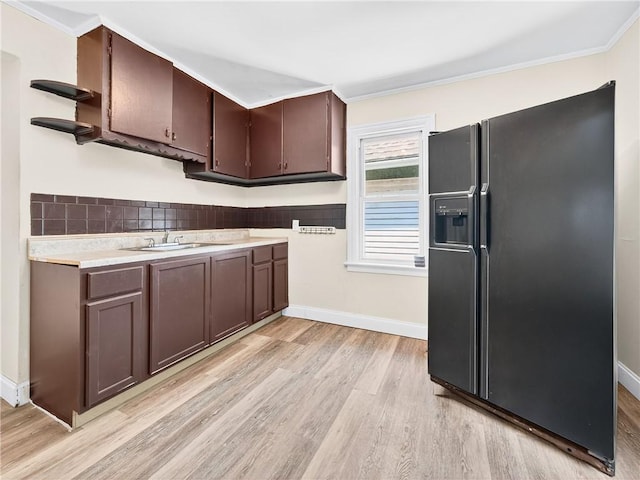 896-898 S Plymouth Ave, Rochester, NY 14608 - kitchen featuring black fridge with ice dispenser, light wood-style flooring, open shelves, light countertops, and ornamental molding