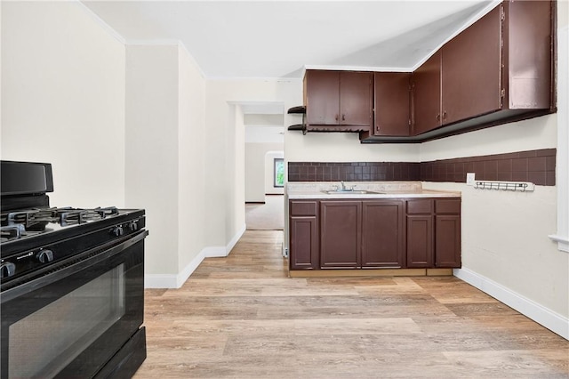 896-898 S Plymouth Ave, Rochester, NY 14608 - kitchen with black gas range, crown molding, light wood-style flooring, dark brown cabinetry, and light countertops