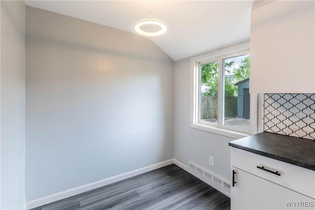 370 W W Girard Blvd, Tonawanda, NY 14217 - unfurnished dining area featuring dark wood-style floors and vaulted ceiling