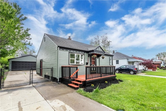 370 W W Girard Blvd, Tonawanda, NY 14217 - view of front of property featuring a gate, an outdoor structure, a wooden deck, roof with shingles, and a detached garage