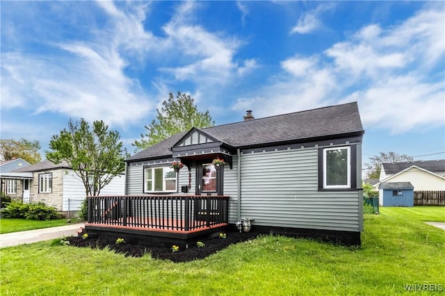 370 W W Girard Blvd, Tonawanda, NY 14217 - rear view of property featuring a wooden deck, a lawn, roof with shingles, and a chimney