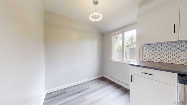 370 W W Girard Blvd, Tonawanda, NY 14217 - unfurnished dining area with light wood-type flooring and vaulted ceiling