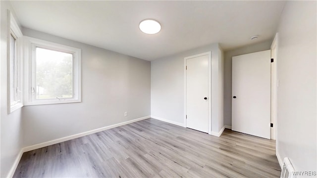 370 W W Girard Blvd, Tonawanda, NY 14217 - unfurnished bedroom featuring light wood-style floors