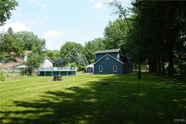 7545 River Rd, Lysander, NY 13027 - view of grassy yard with an outdoor fire pit and view of scattered trees