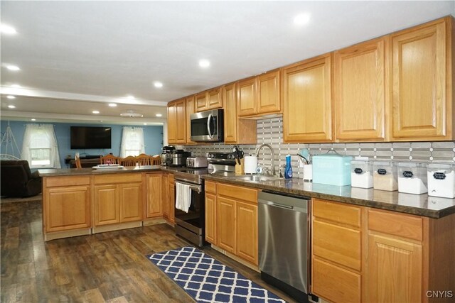 7545 River Rd, Lysander, NY 13027 - kitchen featuring stainless steel appliances, a peninsula, dark countertops, tasteful backsplash, and recessed lighting