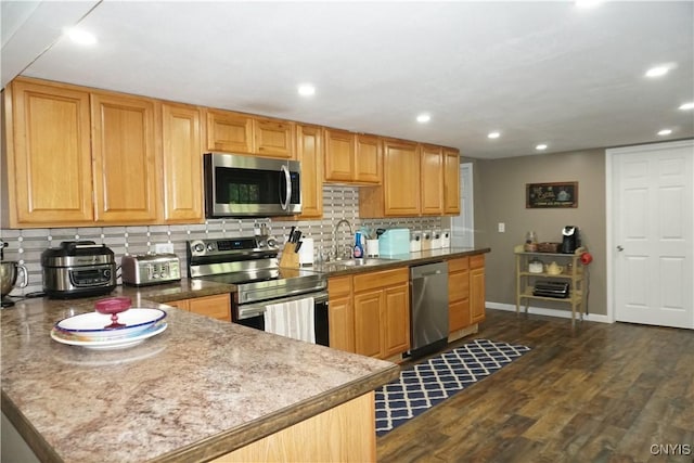7545 River Rd, Lysander, NY 13027 - kitchen featuring stainless steel appliances, decorative backsplash, recessed lighting, dark wood-type flooring, and a peninsula