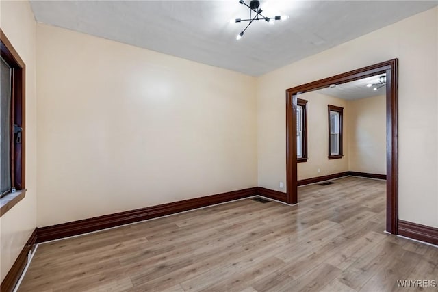 146 Longnecker St, Buffalo, NY 14206 - spare room with light wood finished floors and a chandelier