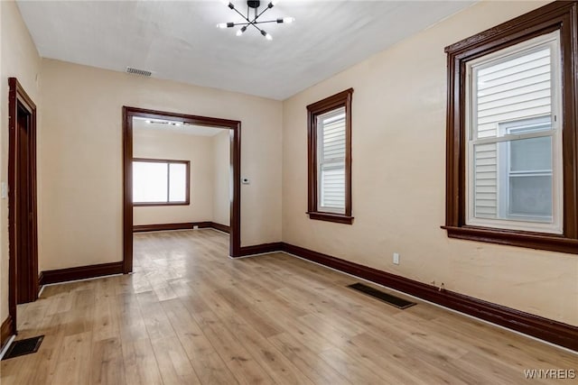 146 Longnecker St, Buffalo, NY 14206 - empty room with a chandelier and light wood-style floors