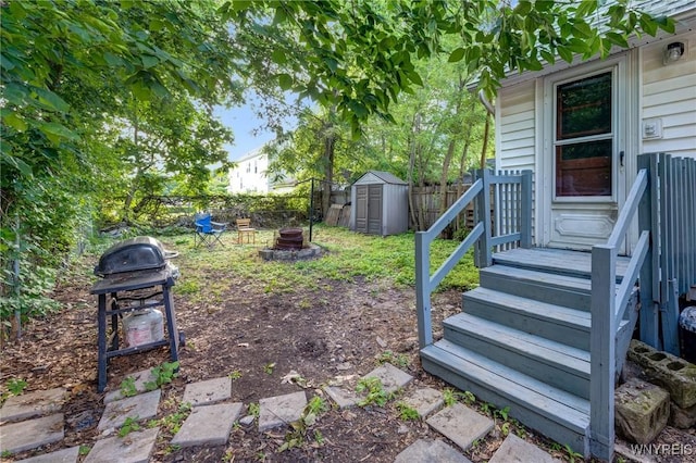 146 Longnecker St, Buffalo, NY 14206 - fenced backyard with a storage unit and a fire pit