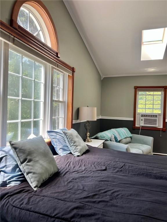 110 Mcmaster St, Bath, NY 14810 - bedroom featuring vaulted ceiling, a skylight, crown molding, and cooling unit