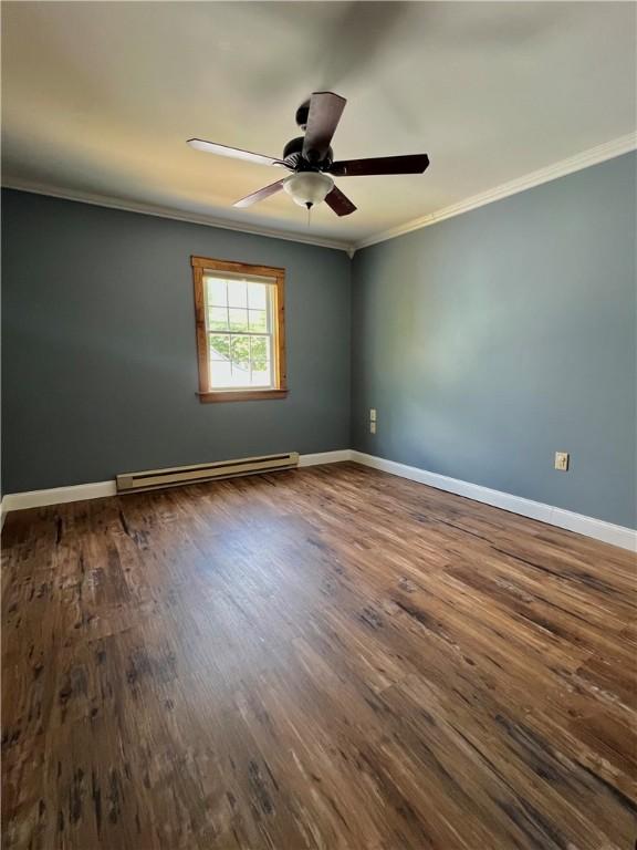 110 Mcmaster St, Bath, NY 14810 - spare room with a baseboard radiator, crown molding, dark wood-type flooring, and ceiling fan