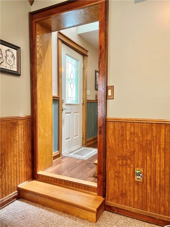 110 Mcmaster St, Bath, NY 14810 - doorway to outside with wainscoting and wooden walls