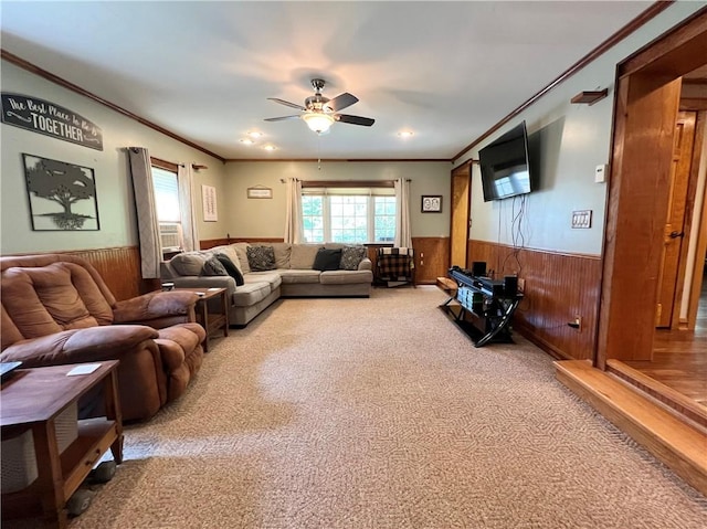 110 Mcmaster St, Bath, NY 14810 - living room featuring a wainscoted wall, wood walls, ornamental molding, a ceiling fan, and carpet floors