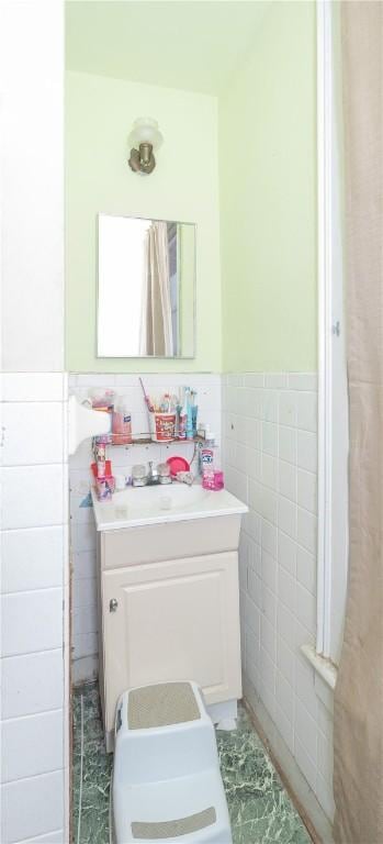 364 W 3rd St, Elmira City, NY 14901 - bathroom with tile walls, vanity, a wainscoted wall, and marble finish flooring