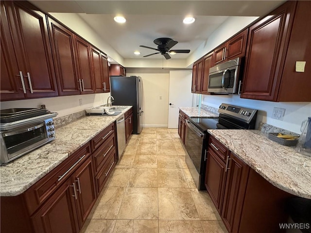 31 Noel Dr, Amherst, NY 14221 - kitchen with appliances with stainless steel finishes, a ceiling fan, light stone counters, recessed lighting, and reddish brown cabinets