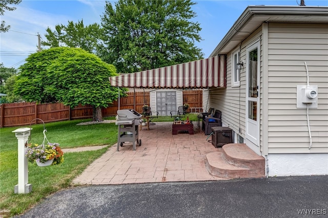 7 Cannas Ct, Cheektowaga, NY 14227 - fenced backyard with grilling area, a patio area, and a storage shed