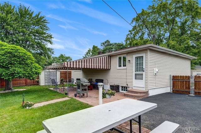 7 Cannas Ct, Cheektowaga, NY 14227 - rear view of house featuring a patio area and a storage unit