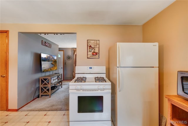 7 Cannas Ct, Cheektowaga, NY 14227 - kitchen with white appliances and light carpet